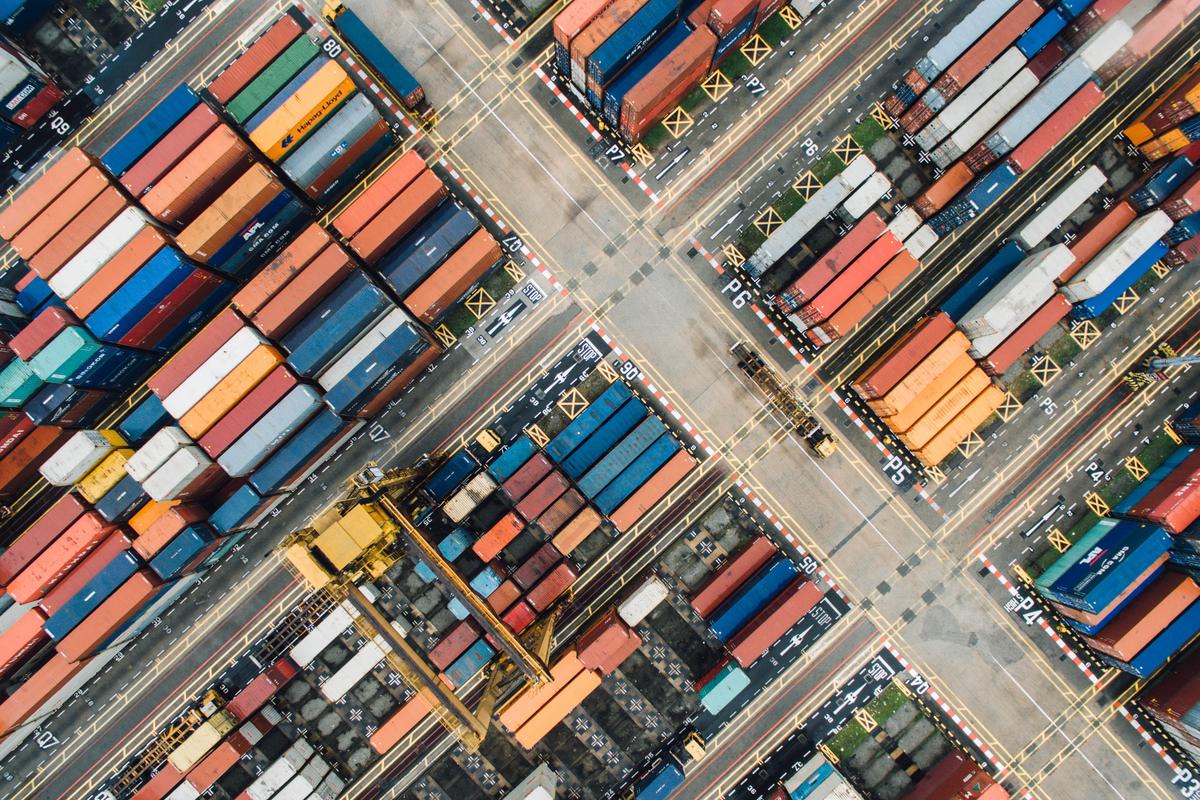Aerial view of shipping containers stacked in the in the terminal yard.