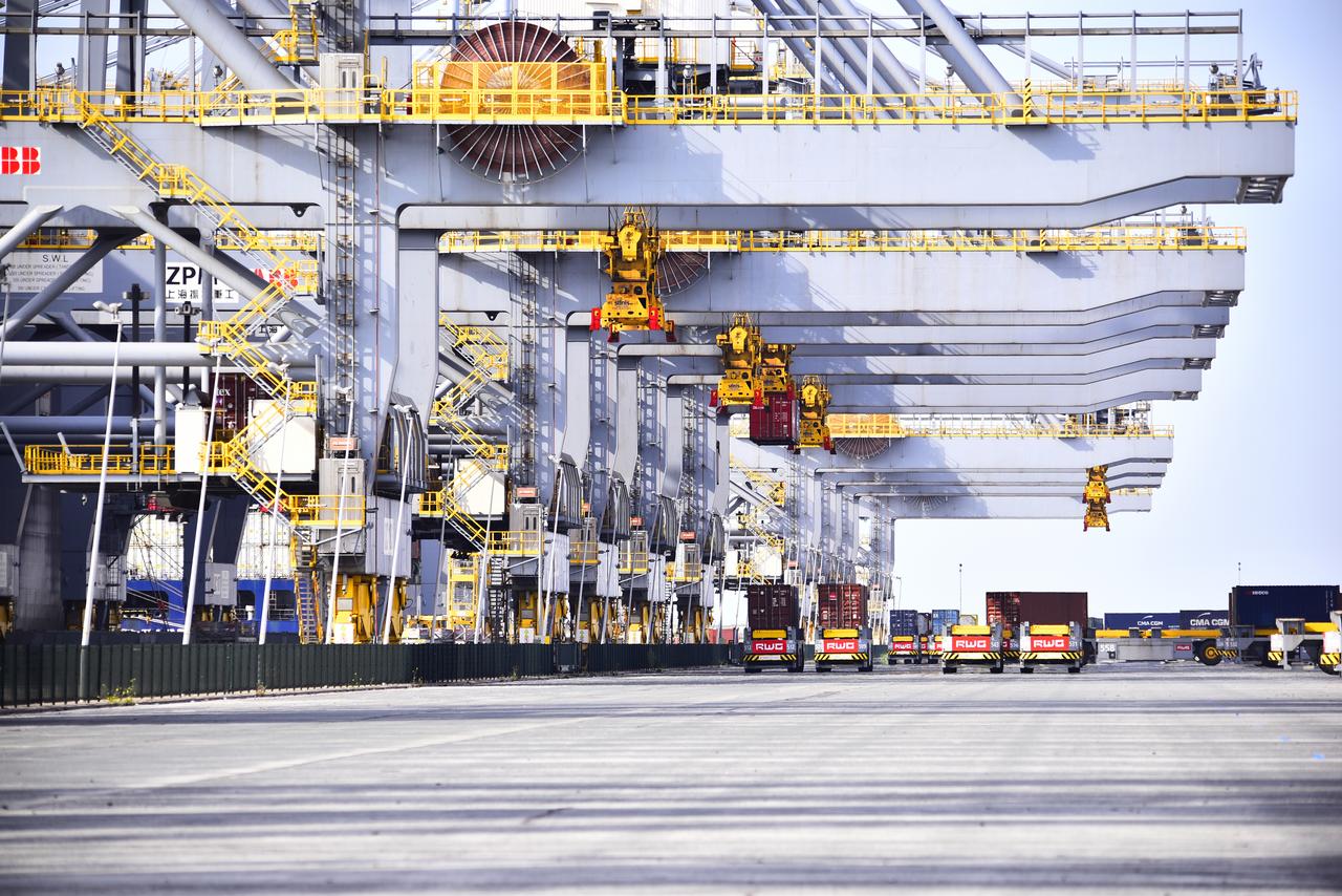 Scenic view of trucks and cranes at Rotterdam terminal