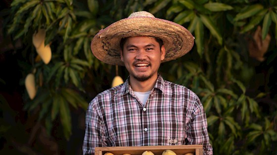 Farmer with mangoes