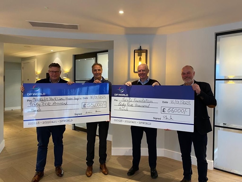 Andrew Bowen, Ernst Schulze, Nick Loader and Steve McCrindle holding two DP World branded cheques